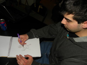 PHOTO BY KATE BAUER  Joshua Joseph drawing in his sketchpad