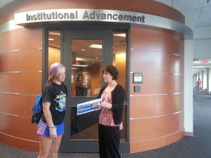 PHOTO BY PRISCILA RIVERA  Lisa Sisson talking to a current students about scholarship applications outside her office 