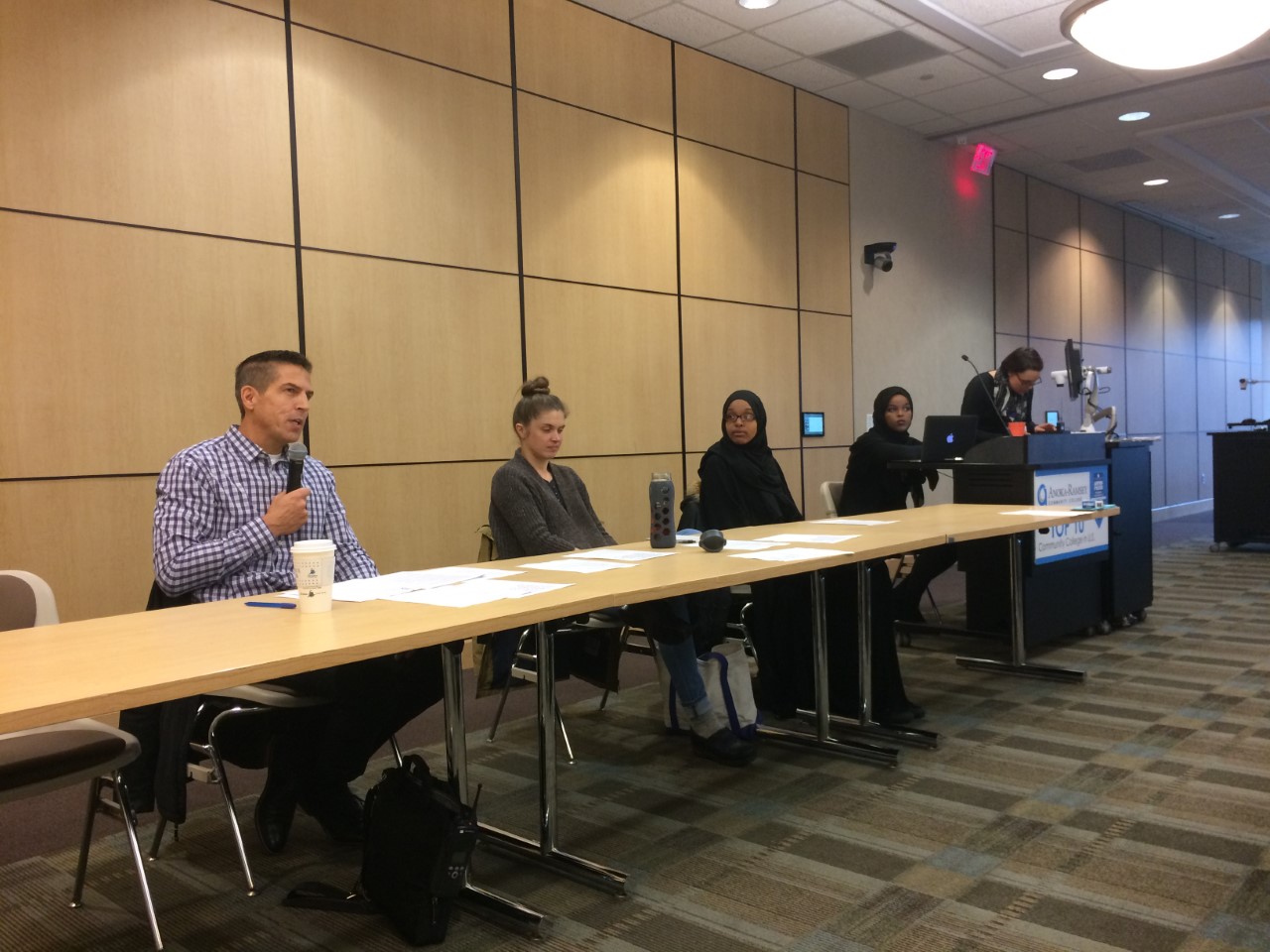 Police Chief Wise responding to a question asked by an audience member. Pictured left to right: Chief of Police Brad Wise, Dr. Kathleen Cole, Twin Cities student Sumaya Abshir, ARCC student Sumeyo Hussein, moderator Melody Hoffmann. Photo credit to Michelle Belmont.